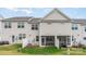 Exterior rear view of the home with a fenced in yard and covered patio area at 6011 Chelsea Oaks Rdg, Tega Cay, SC 29708