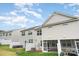 View of home exterior with screen porch, small patio, and well-maintained lawn at 6011 Chelsea Oaks Rdg, Tega Cay, SC 29708