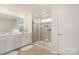 Bright bathroom featuring a double vanity and a tiled glass enclosed shower at 6011 Chelsea Oaks Rdg, Tega Cay, SC 29708