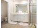 Bright bathroom featuring a double vanity and a tiled glass enclosed shower and toilet at 6011 Chelsea Oaks Rdg, Tega Cay, SC 29708