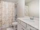 Bright bathroom features a shower with curtain, white vanity, and a large mirror at 6011 Chelsea Oaks Rdg, Tega Cay, SC 29708