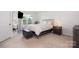 Bright bedroom with ample natural light, a TV, a stylish bed, and tray ceiling at 6011 Chelsea Oaks Rdg, Tega Cay, SC 29708