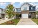 Desirable townhome featuring mixed siding, brick accents, and landscaped front yard at 6011 Chelsea Oaks Rdg, Tega Cay, SC 29708