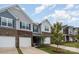 Attractive townhome with a one-car garage, brick facade, and well-maintained landscaping at 6011 Chelsea Oaks Rdg, Tega Cay, SC 29708