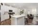 Bright kitchen with stainless steel appliances, an island with seating, and an open layout to the living area at 6011 Chelsea Oaks Rdg, Tega Cay, SC 29708