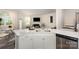 Open-concept kitchen with a sink, dishwasher, quartz countertop, and a view of the living room at 6011 Chelsea Oaks Rdg, Tega Cay, SC 29708