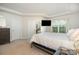 Bright main bedroom featuring a tray ceiling, ample natural light and closet space, and an accent mirror at 6011 Chelsea Oaks Rdg, Tega Cay, SC 29708