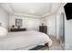 Bright main bedroom with ample closet space, a TV, a stylish bed, and tray ceiling at 6011 Chelsea Oaks Rdg, Tega Cay, SC 29708