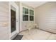 Cozy patio area with neutral siding, a decorative table set, and a door leading inside at 6011 Chelsea Oaks Rdg, Tega Cay, SC 29708
