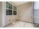 Charming covered patio area features decorative table set, neutral siding and large window at 6011 Chelsea Oaks Rdg, Tega Cay, SC 29708