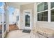 Charming screened-in patio with seating area and an entrance to the backyard at 6011 Chelsea Oaks Rdg, Tega Cay, SC 29708