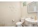 Cozy powder room featuring a pedestal sink, decorative mirror, and wall art at 6011 Chelsea Oaks Rdg, Tega Cay, SC 29708