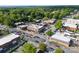 Aerial view of a bustling street crossing with traffic and commercial buildings surrounded by trees at 611 Meadow Lake Dr, Matthews, NC 28105
