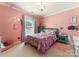 Pink bedroom with crown molding features a window and is decorated with plush toys and pastel decor at 611 Meadow Lake Dr, Matthews, NC 28105