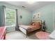 Cozy bedroom in neutral colors features a window, bed with end tables and coordinating wall art at 611 Meadow Lake Dr, Matthews, NC 28105