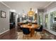 Dining area open to the kitchen featuring a round wood table and hardwood flooring at 611 Meadow Lake Dr, Matthews, NC 28105