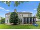 View of home's exterior featuring covered patio with outdoor seating and a lush backyard at 611 Meadow Lake Dr, Matthews, NC 28105