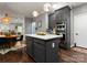 Kitchen featuring island with barstool seating, modern cabinets, and stainless steel appliances at 611 Meadow Lake Dr, Matthews, NC 28105