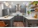 Modern kitchen featuring gray cabinets, stainless steel appliances, and stylish pendant lighting at 611 Meadow Lake Dr, Matthews, NC 28105