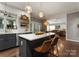 Open kitchen featuring an island with seating and hardwood floors throughout the space at 611 Meadow Lake Dr, Matthews, NC 28105