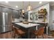 Stylish kitchen with a large island, stainless steel appliances, and modern pendant lights at 611 Meadow Lake Dr, Matthews, NC 28105