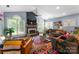 Bright living room featuring a fireplace, cathedral ceiling, and large windows for ample natural light at 611 Meadow Lake Dr, Matthews, NC 28105