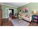 Inviting living room with green walls and french doors leading to the office at 611 Meadow Lake Dr, Matthews, NC 28105