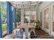 Charming patio with wooden floors, string lights, and outdoor dining table for comfortable entertaining at 611 Meadow Lake Dr, Matthews, NC 28105