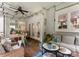 Covered porch featuring a table, chairs, a ceiling fan and an outdoor seating area at 611 Meadow Lake Dr, Matthews, NC 28105