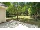 Backyard with grass, mature trees, and a concrete patio; great for outdoor enjoyment at 8221 Brookings Dr, Charlotte, NC 28269