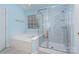 Modern bathroom with a separate shower, tub, and window for natural light at 8221 Brookings Dr, Charlotte, NC 28269