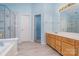 Bright bathroom features a glass shower, soaking tub, and wood-tone vanity with a large mirror at 8221 Brookings Dr, Charlotte, NC 28269