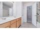Bathroom with a double sink vanity, framed mirror, and tile flooring, adjacent to a bedroom at 8221 Brookings Dr, Charlotte, NC 28269