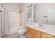 Standard bathroom featuring a shower-tub combo, window, toilet, and wood-tone vanity with mirror at 8221 Brookings Dr, Charlotte, NC 28269