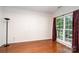 Bright bedroom featuring hardwood floors, crown molding, and large windows at 8221 Brookings Dr, Charlotte, NC 28269