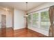 Sunny dining area with hardwood floors, natural light, and access to a bathroom and other rooms at 8221 Brookings Dr, Charlotte, NC 28269