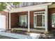 Welcoming front porch with seating and beautiful landscaping, offering a cozy curb appeal at 8221 Brookings Dr, Charlotte, NC 28269