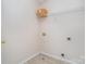 Small laundry area features tile flooring, wire shelving, and washer/dryer hookups at 8221 Brookings Dr, Charlotte, NC 28269