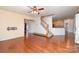 Open living space with hardwood floors, a ceiling fan, and seamless flow to the kitchen at 8221 Brookings Dr, Charlotte, NC 28269