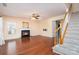 Inviting living room featuring hardwood floors, a fireplace, and easy access to the staircase at 8221 Brookings Dr, Charlotte, NC 28269