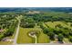 Expansive aerial view of home, surrounding acreage, mature trees, outbuildings, and adjacent neighborhood at 8825 Harris Rd, Concord, NC 28027