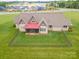 Aerial view of a house with a fenced yard and well-maintained lawn at 8825 Harris Rd, Concord, NC 28027