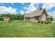 Spacious backyard with lush green grass and a detached outbuilding in the distance at 8825 Harris Rd, Concord, NC 28027