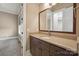 Bathroom featuring a granite countertop, wood cabinets and large mirror at 8825 Harris Rd, Concord, NC 28027