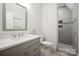 Modern bathroom with gray vanity, quartz countertop and tiled walk-in shower at 8825 Harris Rd, Concord, NC 28027