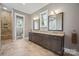 Bathroom with double vanity, tile floors, framed mirrors, and glass enclosed shower at 8825 Harris Rd, Concord, NC 28027