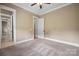 Neutral-toned bedroom with crown molding and carpet flooring leads to hallway at 8825 Harris Rd, Concord, NC 28027