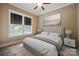 Comfortable bedroom featuring neutral colors, a ceiling fan, and natural light from the windows at 8825 Harris Rd, Concord, NC 28027