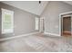 Spacious bedroom with plush neutral carpet and large windows offering ample natural light at 8825 Harris Rd, Concord, NC 28027