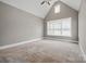 Large bedroom with vaulted ceilings, carpet floors, and ample natural light from large windows at 8825 Harris Rd, Concord, NC 28027